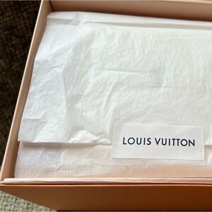 LV candle. Never lit but did sit outside the box. Includes all original package